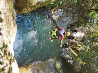 Man jumping in the water during his session of Canyoning in the Lower Canyon des Écouges from Terra Nova Canyoning.