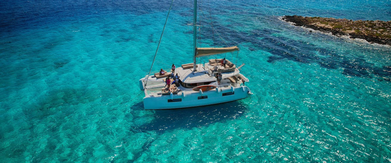 The boat that is used during the Private Catamaran Trip to Paros and Antiparos with Snorkeling and BBQ from Captain Yannis Cruises Catamaran Paros in crystal clear waters.
