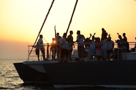 People partying on a Sunset Catamaran Trip in the Camargue with a different theme every day from Catamaran Picardie.
