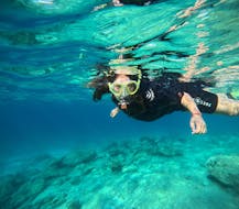 A woman snorkeling while the Private Snorkeling Trip around Paros organized by H2O DIVING NOMADS PAROS.