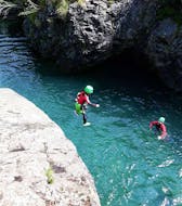 Boy jumping in the water during his Aquatic Canyoning in the Pyrenees for Beginners from Canyoning Natureo 65 Pyrénées.