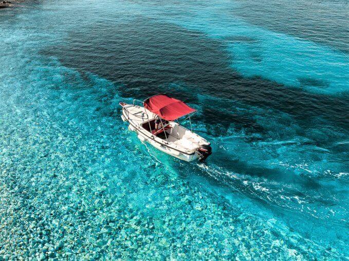 Boat in blue water during Boat Rental in Vela Luka with License (up to 6 people) from Proizd Boat Tours Vela Luka.