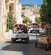 Image of Jeeps driving through a narrow street of a village during the boat and Jeep tour around Gozo and Camino from Barbarossa Excursions Malta.