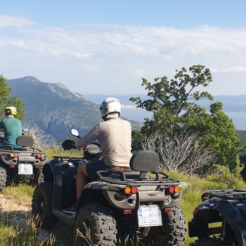 Image of people driving quads along a scenic dirt road during a Quad Tour from Bol across Brač Island from Maestral Travel Bol.