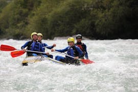 A group of people participating in the tour Rafting in “Mini Rafts” for Explorers - Ziller with Mountain Sports Mayrhofen is navigating their raft along the rousing rapids of the river.