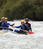 A group of people participating in the tour Rafting in “Mini Rafts” for Explorers - Ziller with Mountain Sports Mayrhofen is navigating their raft along the rousing rapids of the river.