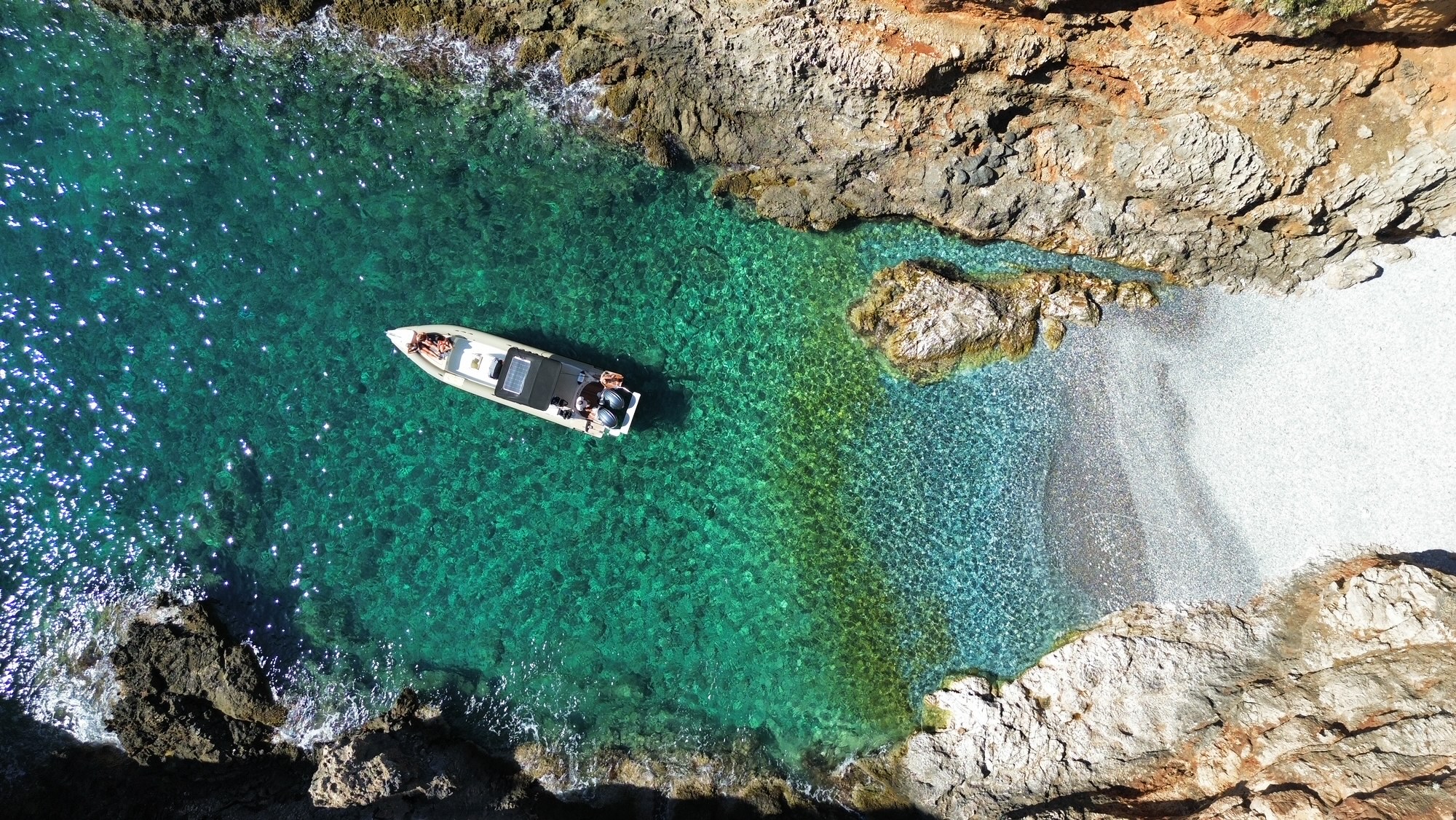 The boat "Skipper 33" anchors in a bay during the Boat Rental in Chania (up to 9 people) with Skipper organized by Sun & Sea Chania Boat Rental.