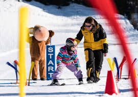 Private Ski Lessons for Kids of All Levels from Ski- & Snowboard School Florian Kleinarl An instructor and a kid during the Private Ski Lessons for Kids of All Levels from Ski- & Snowboard School Florian Kleinarl.