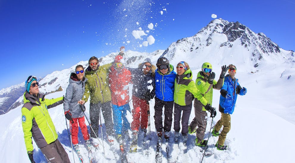 Des skieurs jettent de la neige en l'air après leur Cours de ski Adultes (dès 14 ans) - Max 7 par groupe avec Prosneige Méribel.