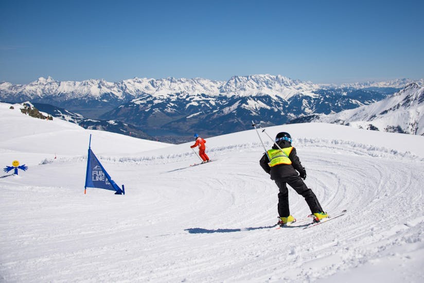 A child skiing after his instructor during private ski lessons for kids of all levels with Ski Dome Oberschneider in Kaprun.