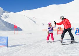 A girls is happy with the achievements during the private skie lessons for kids with Skischule Innsbruck.