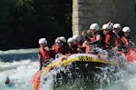 The participants of Rafting in the Imster Schlucht from Haiming with CanKick Ötztal are paddling through a rapid on the Inn river.