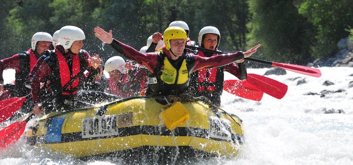A group of people is highly focussed on navigating the rapids of the Inn River during their Rafting Daytrip on the Inn River through Imster Schlucht with CanKick-Ötztal.