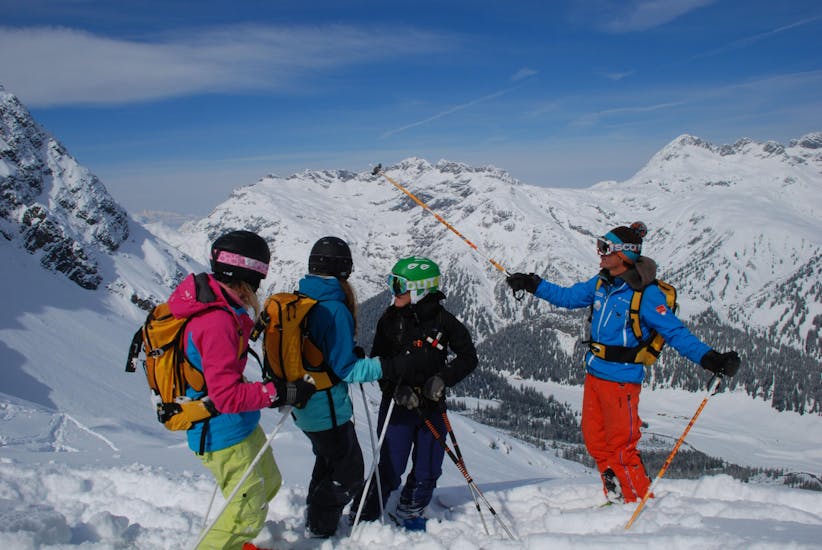 Eine Gruppe von Skifahrern auf den Berggipfeln während ihres privaten Kinder-Skikurses aller Altersgruppen in Lech mit der Skischule Warth.