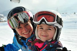 An instructor and child during private ski lessons for kids of all ages in Lech with ski school Warth.