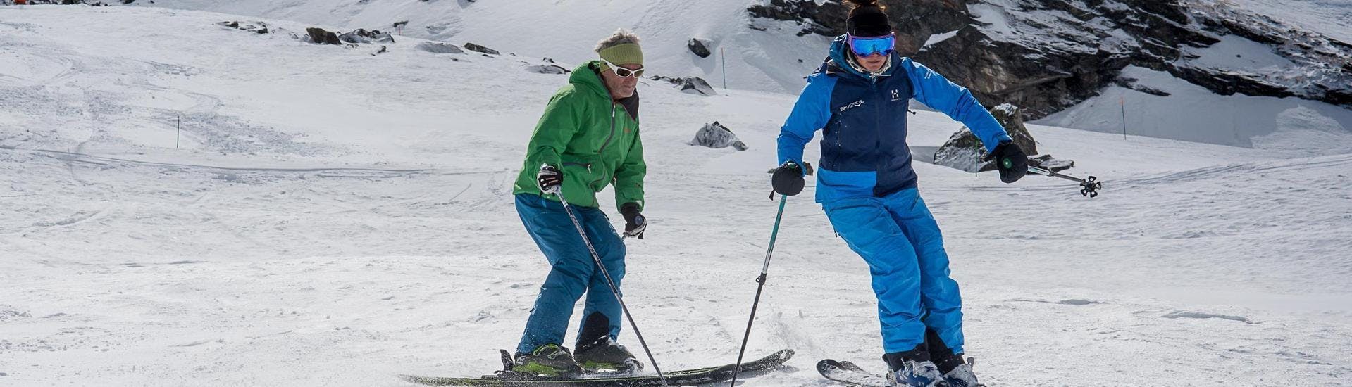 A skier is following his instructor from the ski school Ski Cool down the slope in the ski resort of Val Thorens.