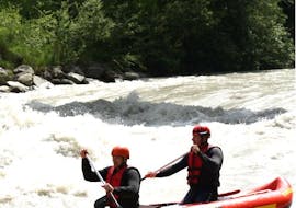 2 men paddling down the Imster Schlucht on their Rafting Tour in a 2-man raft organized by Natur Pur Outdoorsports.