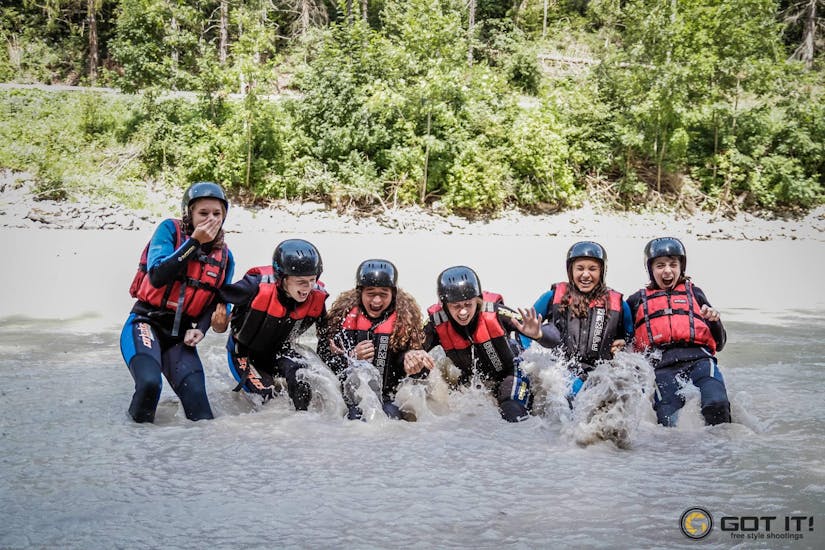 Eine Gruppe von Teilnehmern fällt ins Wasser während des Rafting auf dem Inn - Perfekter Start mit H2O Adventure Ried.