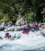 People fighting whitewater while X-treme Rafting on the Ötztaler Ache with H2O Adventure Ried.