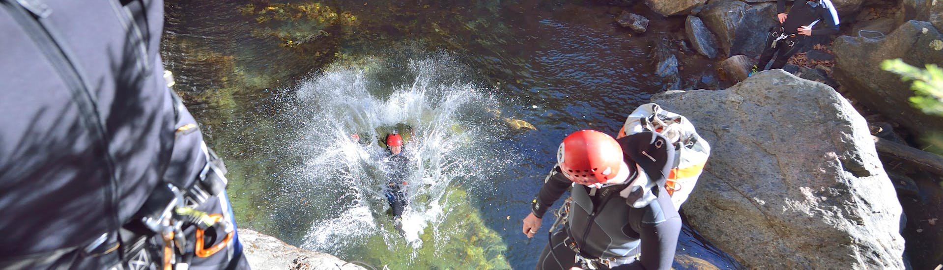 A woman landing in the water while Canyoning near Ried im Oberinntal - Pure Action with H2O Adventure Ried.