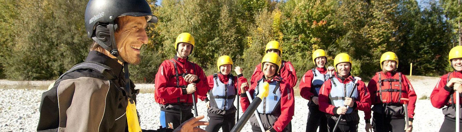 An experienced rafting guide from Montevia is explaining the basics of rafting to a group of participants before they empark on their Rafting for Beginners on the Isar river.