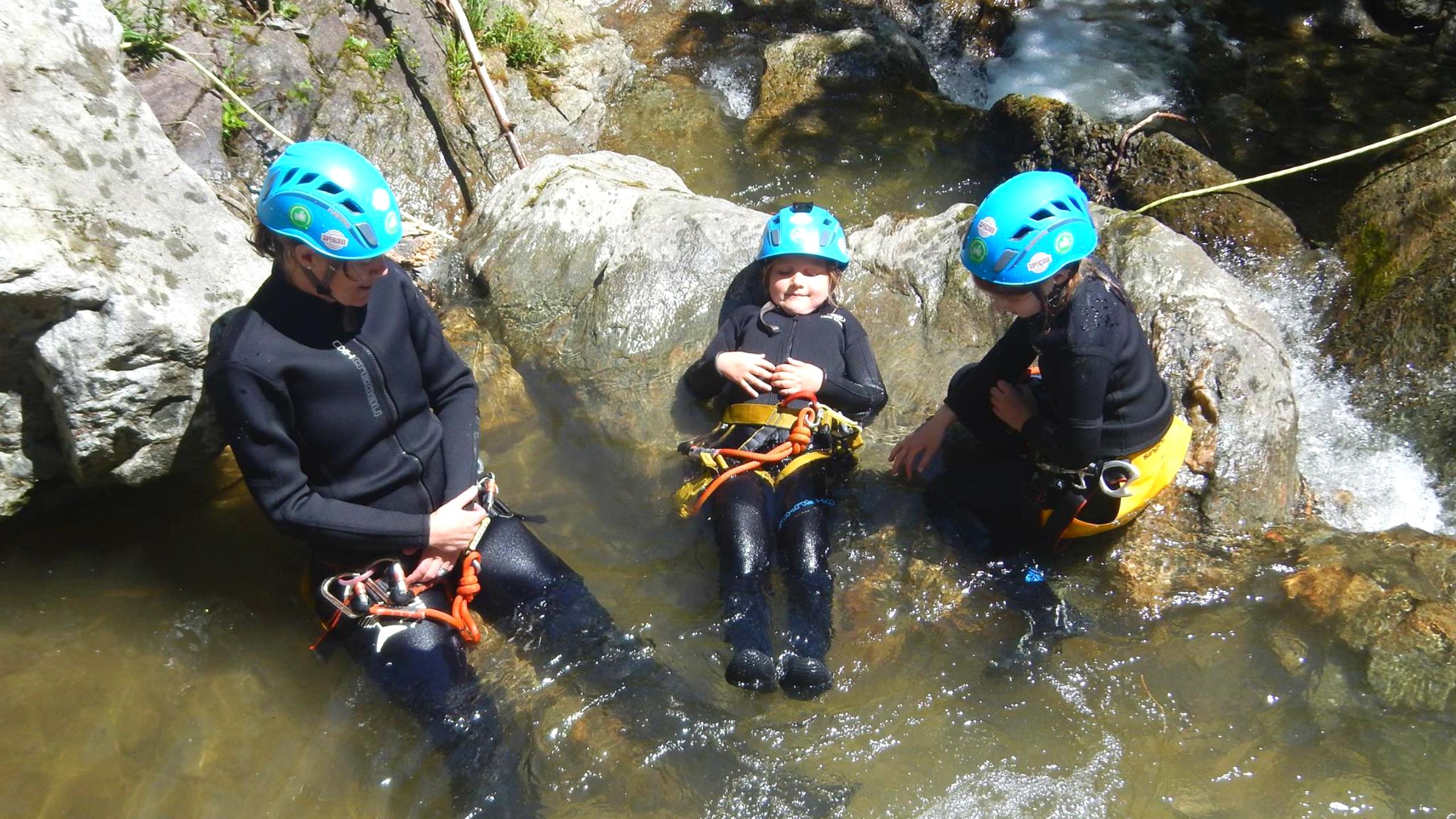 A family enjoying the refreshing water of the beautiful natural pools on their Canyoning Tour for Kids with the experienced team of Frost Rafting & Canyoning Tours.