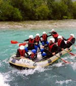 A group of rafters is paddling along the river during their Rafting for Adventurers on the Ziller with Freiluftakademie.