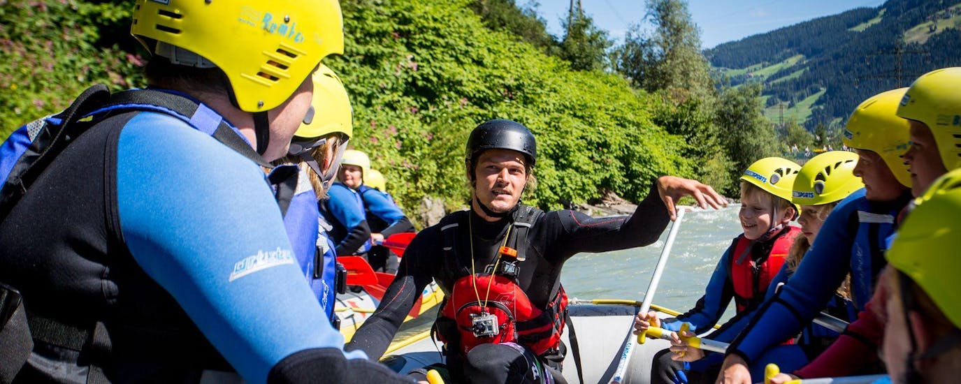 Ein Guide von Mountain Sports Mayrhofen erklärt bei der Tour Rafting für Familien - Ziller wie man das Boot richtig steuert.