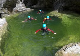 During the Canyoning for Beginners - Almbachklamm, a group of people is having fun in a canyon under the guidance of an experienced guide from Bergführer Salzburg.