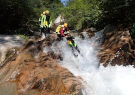 Sliding down a natural water slide during Fun Canyoning in the Wöllaschlucht in Mölltal with CAM & COOL'S Kärnten & Osttirol