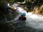 A woman having fun while Canyoning in East Tyrol - First Step Tour with Adventurepark Osttirol.