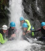 People under a waterfall while Canyoning in East Tyrol - Sports Tour with Adventurepark Osttirol.