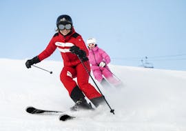 A skier follows his instructor during a private ski lesson for adults with the ESF Courchevel Village.