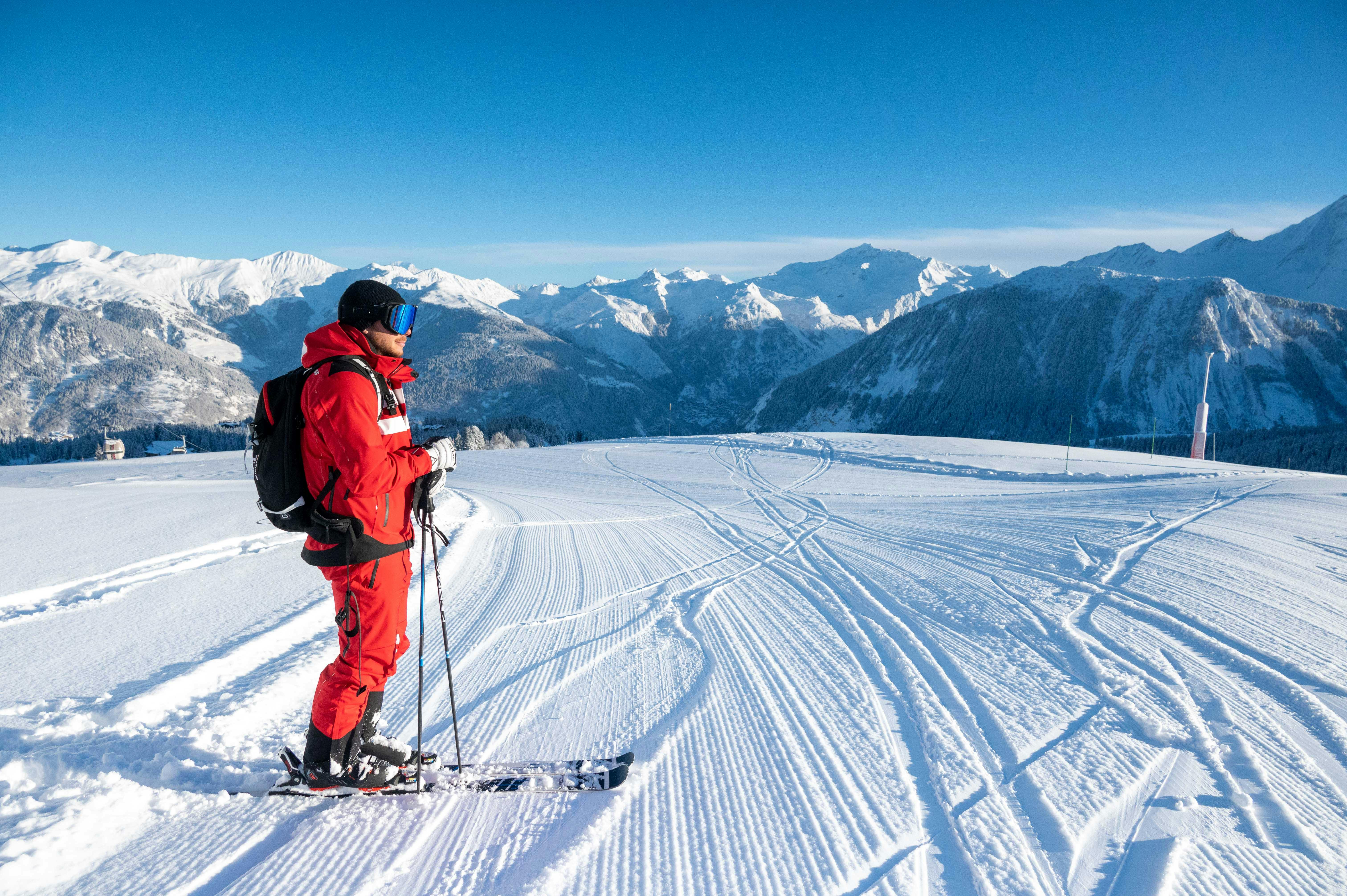 A skier follows his instructor during a private ski lesson for adults with the ESF Courchevel Village.
