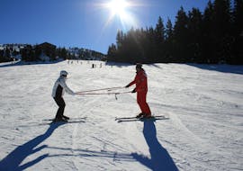 A beginner skier is practicing some basic techniques with their ski instructor from the ski school Skischule Lechner during the Private Ski Lessons for Adults - All Levels.