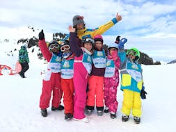 A group of young skiers celebrate the end of their lesson ski and the progress they have made with Villars Ski School.