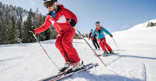 Adult Ski Lessons (from 16 y.) for Advanced Skiers with the HERBST Ski School Lofer An instructor and an adult hitting the slopes during the Adult Ski Lessons (from 16 y.) for Advanced Skiers with the HERBST Ski School Lofer.