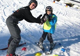 An instructor is teaching a young boy during private ski lessons for kids from 7 years - All Levels in the Schneesportschule Black Forest Magic Feldberg.