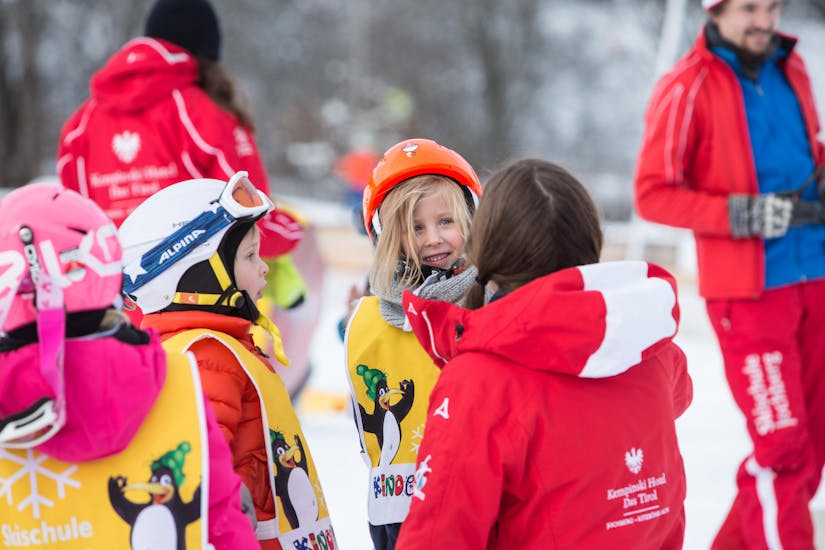 A group of kids during their kids ski lessons bambini with ski school Jochberg.