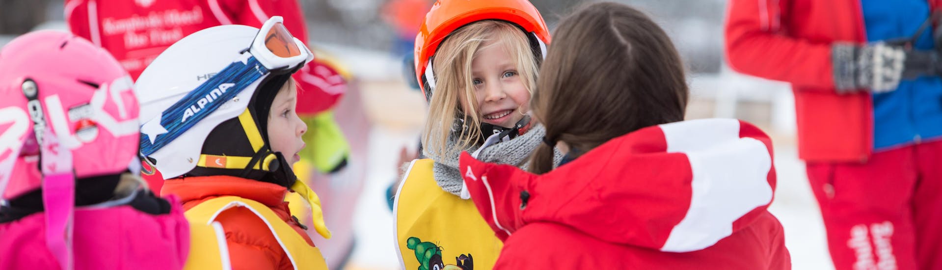 A group of kids during their kids ski lessons bambini with ski school Jochberg.