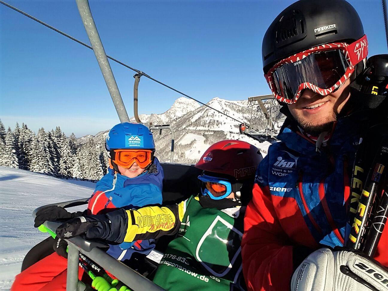 Children on the chair lift with ski instructor of the alpine and winter sports school TOP ON SNOW Sudelfeld