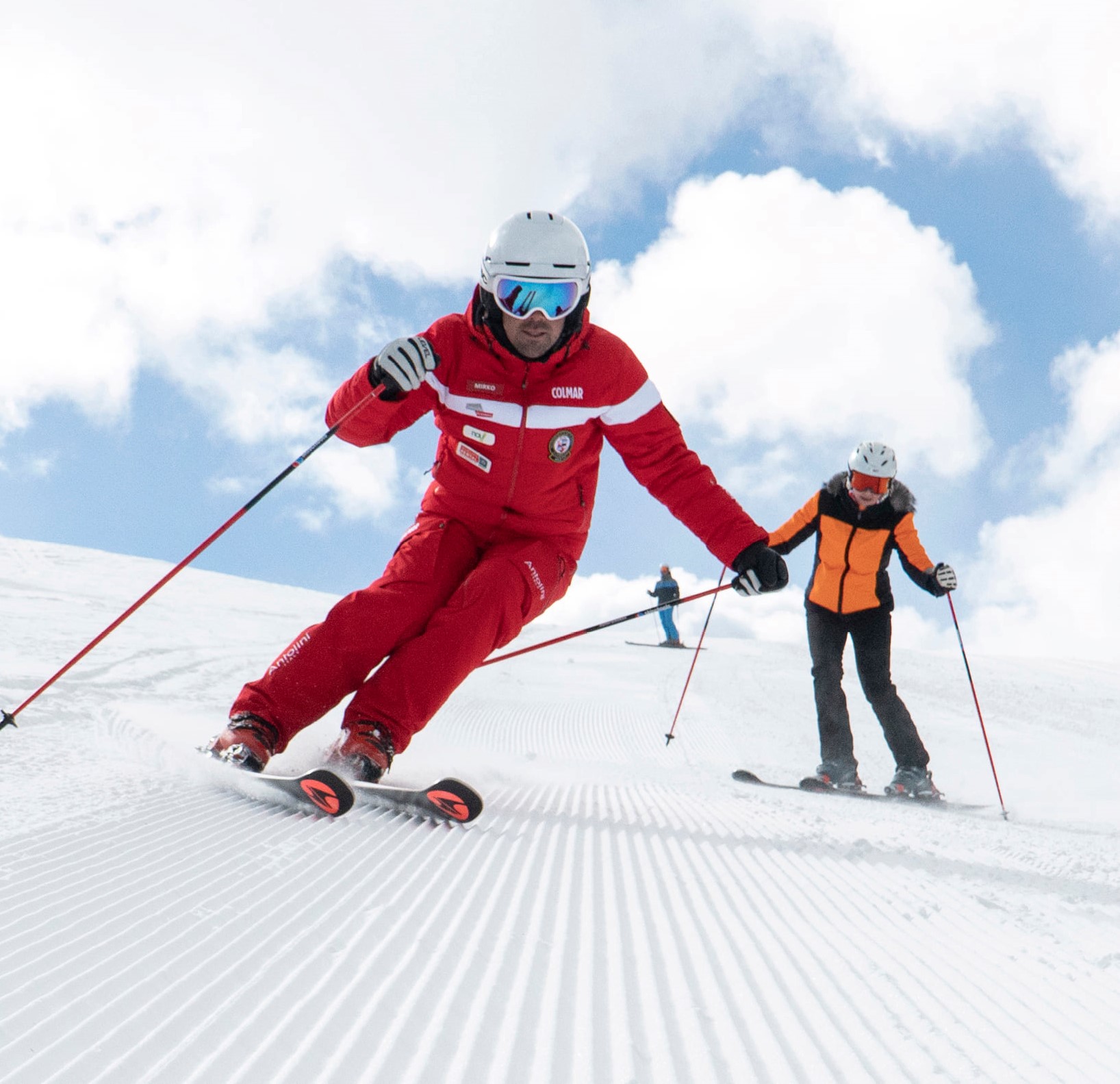 Ski instructor paving the way for a participant during one of the adults ski lessons for advanced skiers in Selva di Val Gardena.