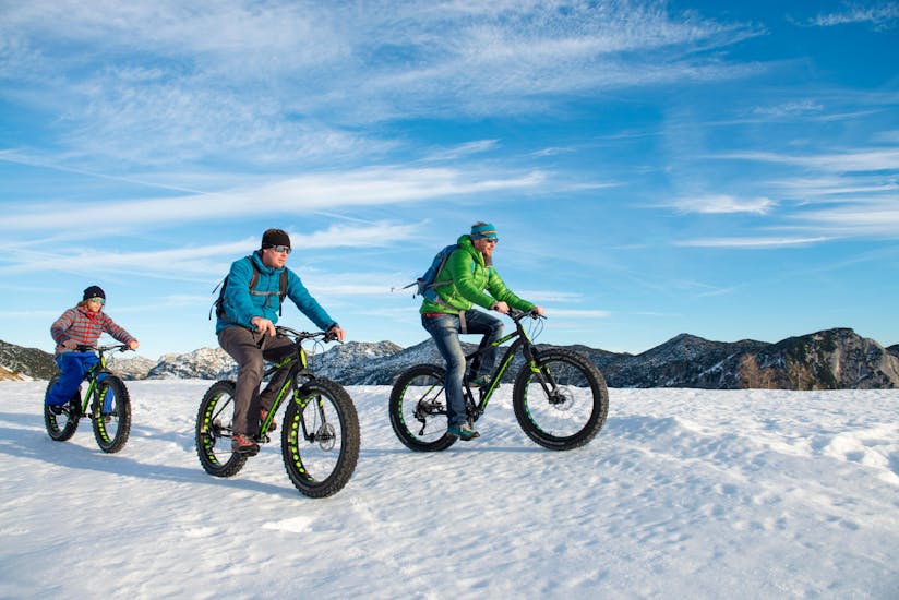 A group of three enjoying the winter landscape during their Fatbike Tour for All Levels & Ages from Snow & Mountain Sports Loitzl Loser.