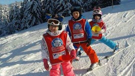 Three children riding the snow plough during Kids Ski Lessons (3-12 y.) for All Levels "Half Day" with Schi- & Snowboardschule Radstadt.