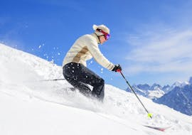 A skier is skiing down a snowy slope during his Private Off-Piste Skiing Lessons for Adults – All Levels with the ski school Prosneige Méribel.