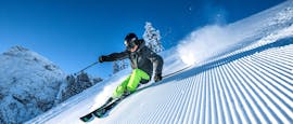 A skier is showing his skills he learnt during adult ski lessons for advanced skiers with ski school Ruhpolding at the Westernberg ski area.