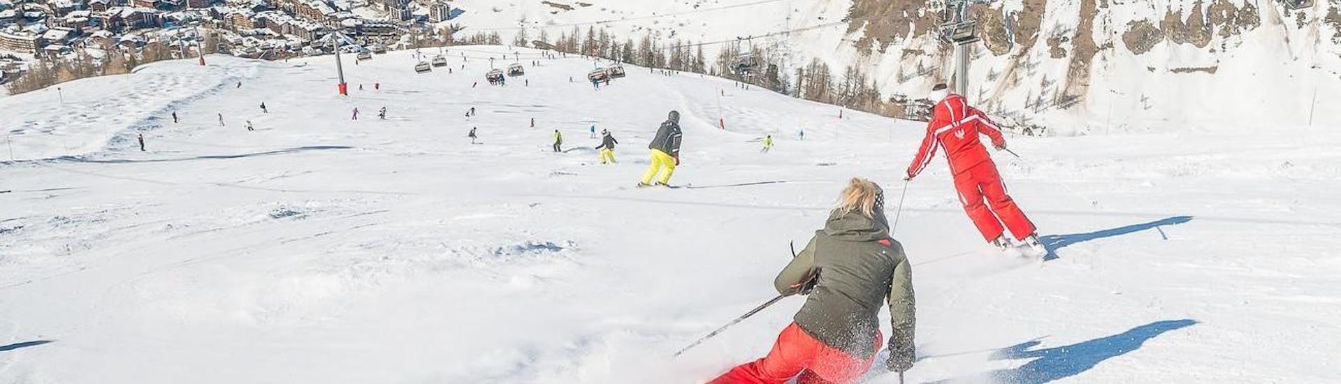 Adult skiers are learning how to ski while keeping the right ski stance in the Ski Lessons for Adults - All Levels organised by the school ESF Val d'Isère.