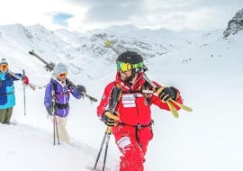 A ski instructor from the ski school ESF Ski School Val d'Isère is heading to the top of the mountain with a group of ski enthusiasts to offer them a great experience during the Private Off-Piste Skiing Lessons - All Levels.