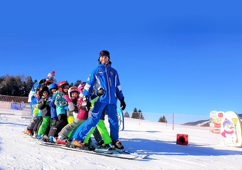 Dobbiaco Ski instructor with group of kids