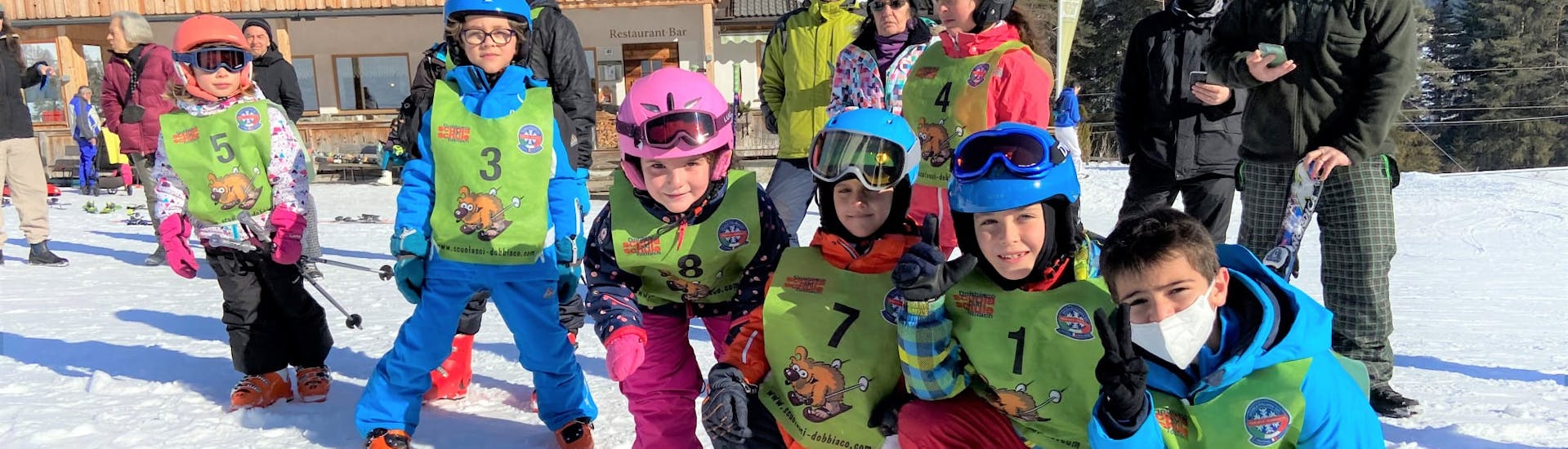 Group of kids at the base station after Kids Ski Lessons for Advanced with Ski School Dobbiaco.